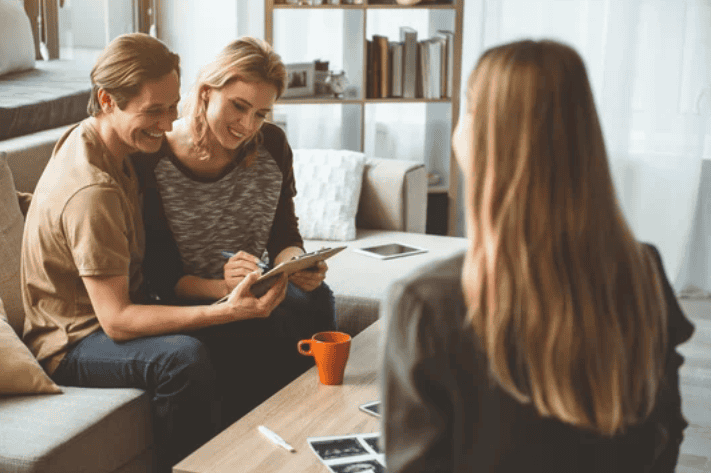 A couple and parents interviewing a surrogate at a match meeting